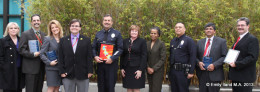 A large group of people from the Autism Society of Los Angeles and LAPD pose at an awards ceremony